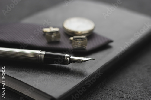 Black style Man set: notepad, pen and cufflinks. Black background