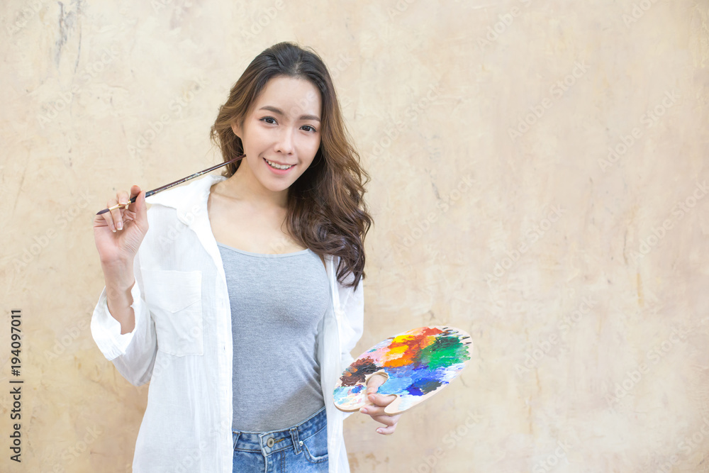Asian woman painting in her studio. People with art concept.