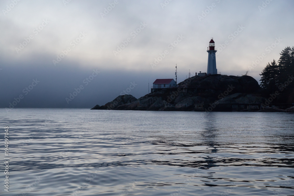 View of the Lighthouse Park during a fog covered sunset. Taken in Horseshoe Bay, West Vancouver, British Columbia, Canada.