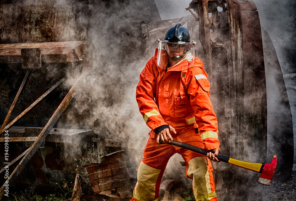 Fototapeta premium Emergency Fire Rescue training, firefighters in uniform, arm with a fire axe