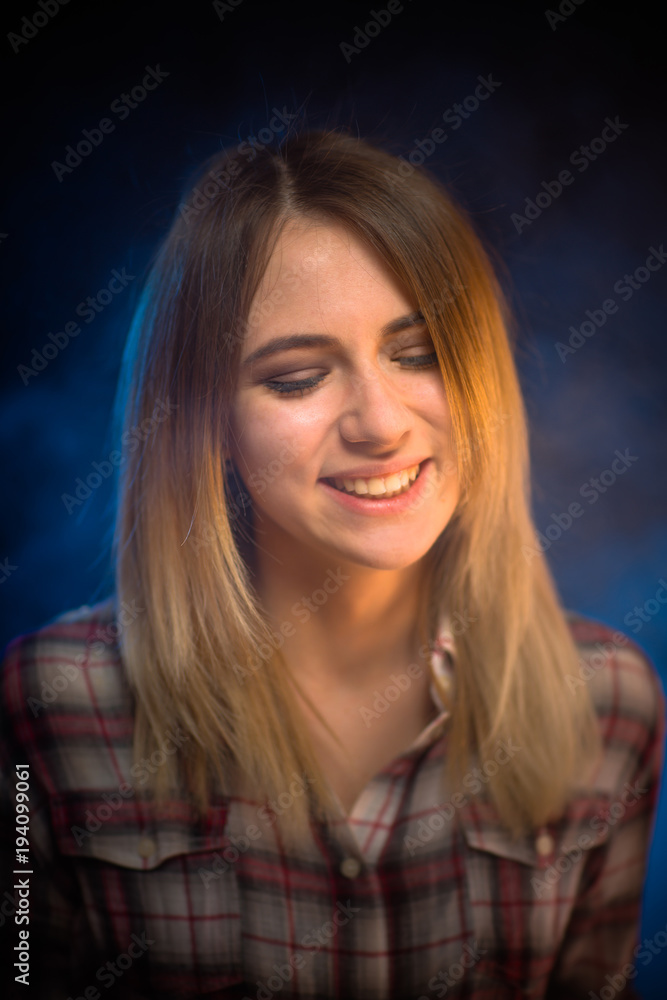 portrait smiling girl on blue background in studio portrait smiling girl on blue background in studio