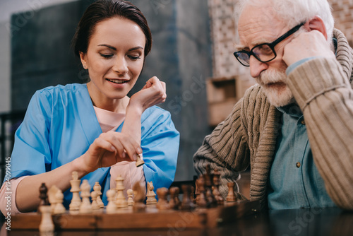 фотографія Nurse and senior man passionate about chess