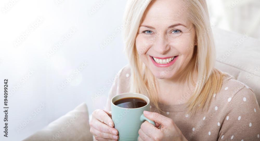 Portrait of happy blonde with mug in hands Portrait of happy blonde with mug in hands