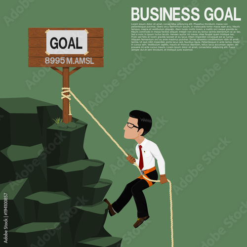 A businessman  is climbing the cliff
