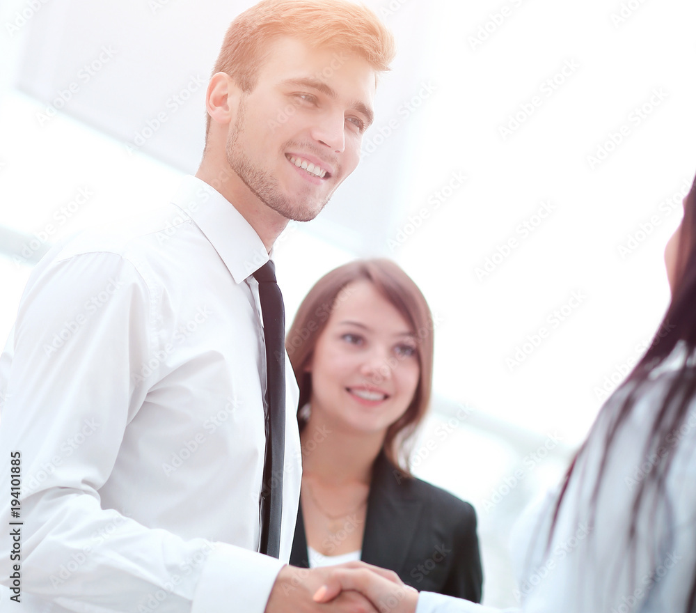 welcome and handshake of business partners in the office. welcome and handshake of business partners in the office.