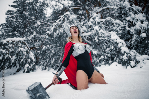 Fotografie Furious woman in image of Germanic-Scandinavian God of thunder and storm