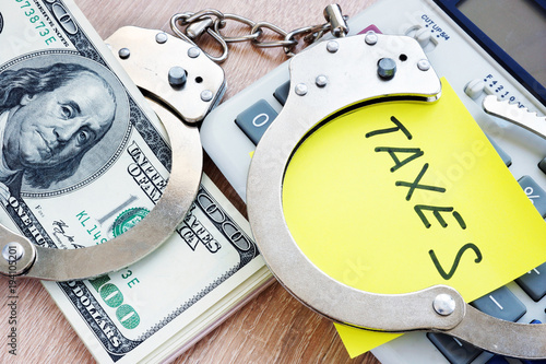 Obraz na plátně Problems with taxes. Handcuffs and money. Tax evasion concept.