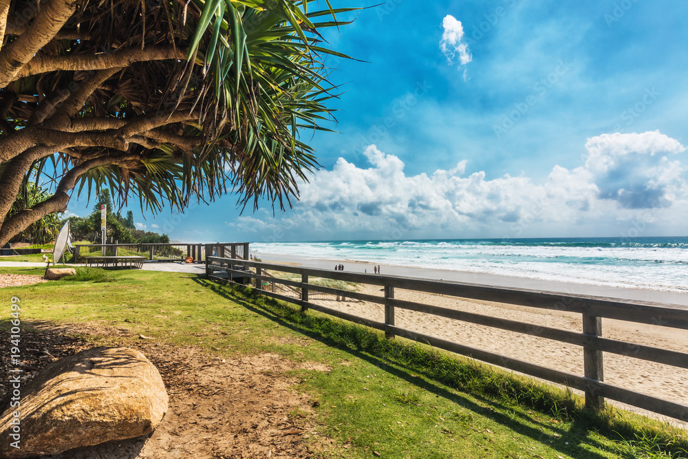 COOLUM, AUSTRALIA, FEB 18 2018: People enjoying summer at Coolum main beach - famous tourist destination in Queensland, Australia. - obrazy, fototapety, plakaty 
