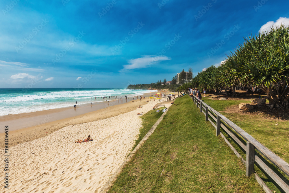 Fototapeta premium COOLUM, AUSTRALIA, FEB 18 2018: People enjoying summer at Coolum main beach - a famous tourist destination in Queensland, Australia