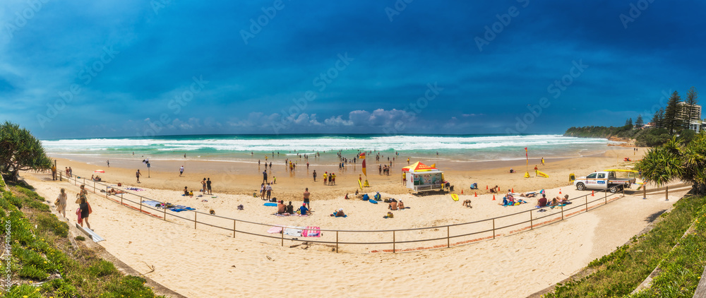 Fototapeta premium COOLUM, AUSTRALIA, FEB 18 2018: People enjoying summer at Coolum main beach - a famous tourist destination, Queensland, Australia.