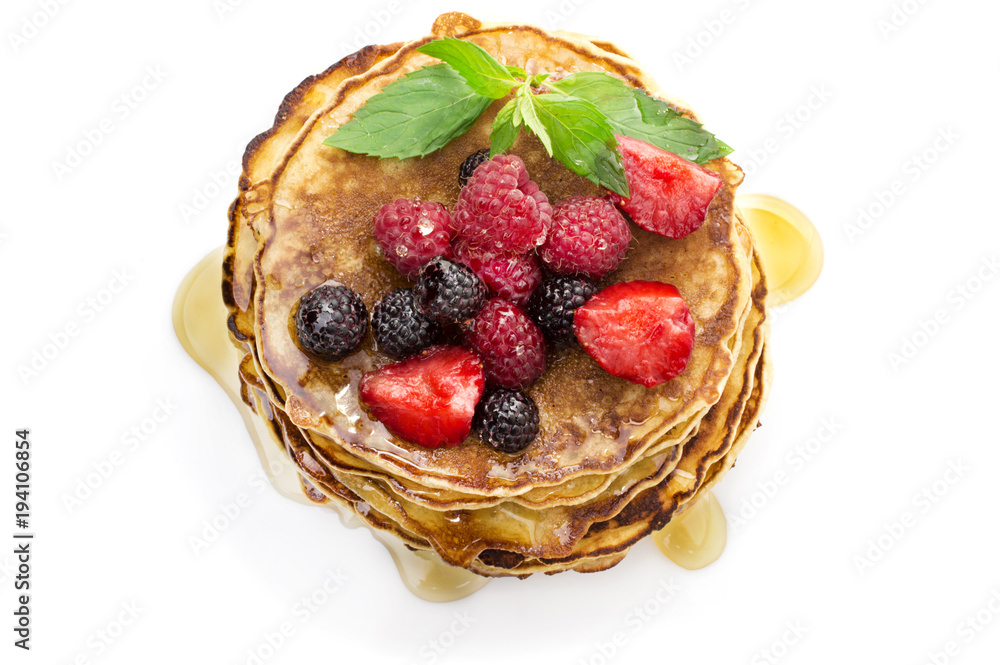 Delicious pancakes with berries and maple syrup top view, white background Delicious pancakes with berries and maple syrup top view, white background