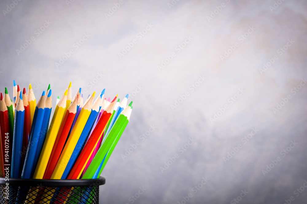 Obraz premium Pencils colorul color wooden pencil in metal holder in front of wall background