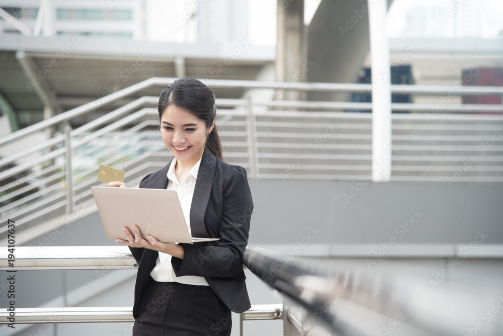 businesswoman using computer and credit card for shopping online. internet banking and e-commerce technology concept. panoramic banner with copy space. businesswoman using computer and credit card for shopping online. internet banking and e-commerce technology concept. panoramic banner with copy space.
