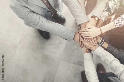 Group of successful business people hand to hand