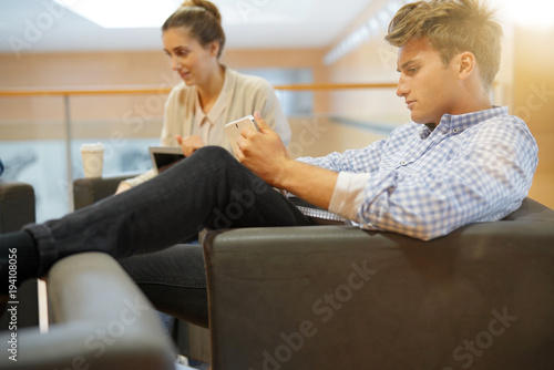 Students in lounge room connected with tablets