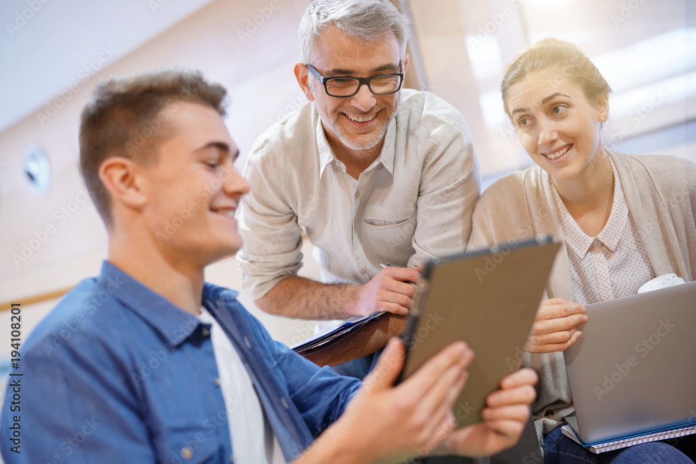 Group of students in lounge room with teacher Group of students in lounge room with teacher