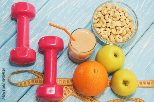 The concept of a healthy diet. Small dumbbells, juice. Apples. healthy lifestyle. sport. Fitness food.