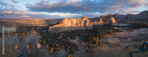 Aerial panoramic view of a beautiful landmark, Smith Rock, famous for rockclimbing. Taken in Redmond, Oregon, America, during a vibrant sunrise.