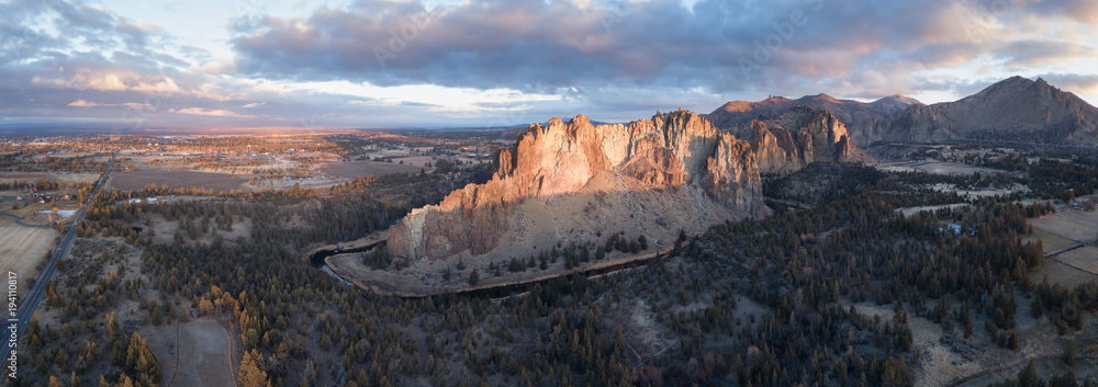 Aerial panoramic view of a beautiful landmark, Smith Rock, famous for rockclimbing. Taken in Redmond, Oregon, America, during a vibrant sunrise.