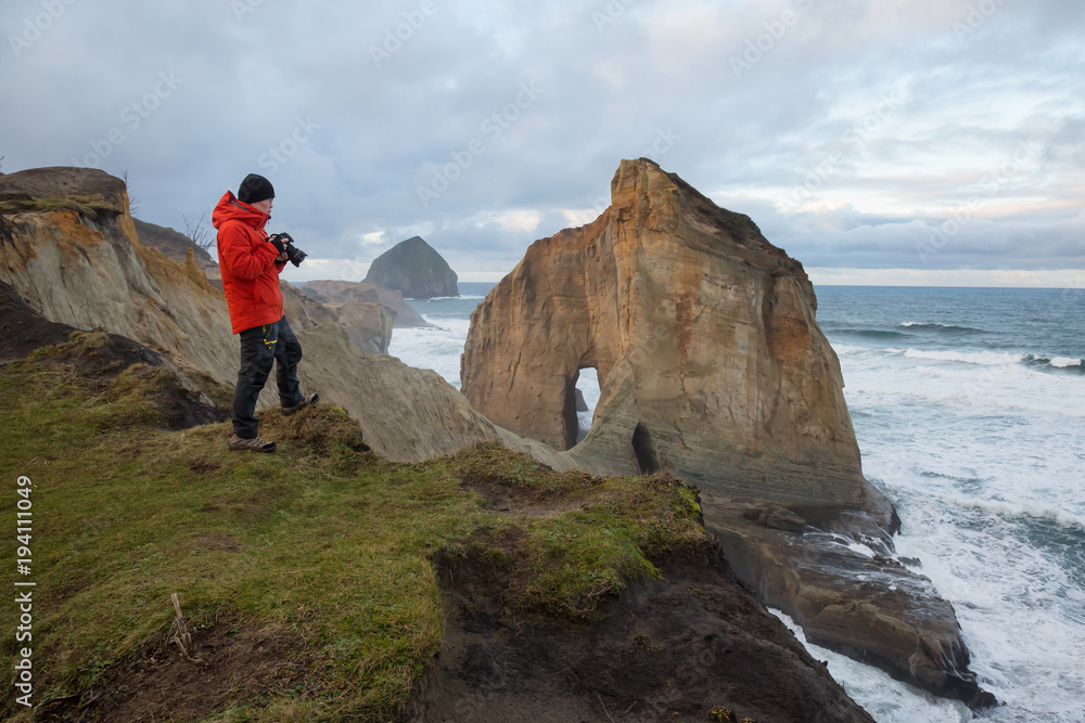 Photographer taking pictures of Kape Kiwanda in Oregon Coast, United States of America
