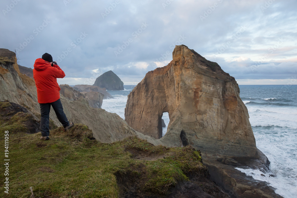 Photographer taking pictures of Kape Kiwanda in Oregon Coast, United States of America