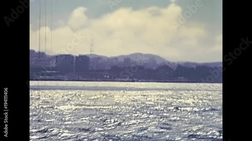 Alcatraz island in San Francisco Bay skyline. Sea view from boat touristic tour. Archival San Francisco restored footage in California, United States in 1980.