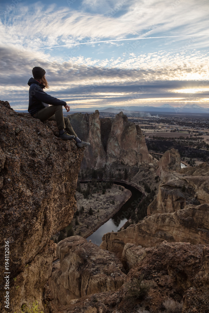Man enjoying the Beautiful American Mountain Landscape during a vibrant winter day. Taken in Smith Rock, Redmond, Oregon, America. Concept: Adventure, Holiday and Travel