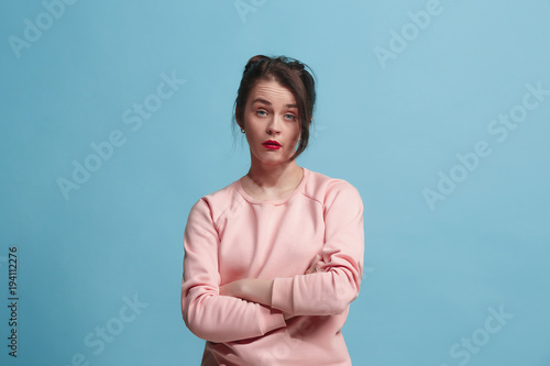 Beautiful bored woman bored isolated on blue background photo