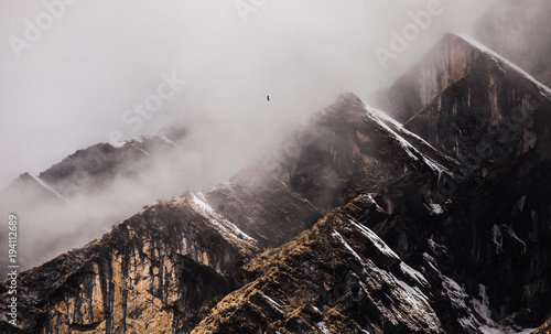 Majestical mountains in clouds in Nepal. Landscape with beautiful high rocks and dramatic cloudy sky. Nature background. Fairy scene. Amazing mountains photo