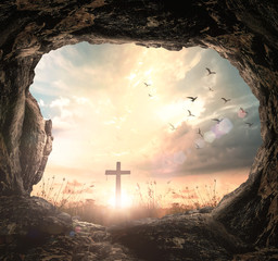 Empty tomb of Jesus Christ with cross at sunrise, resurrection and easter sunday concept