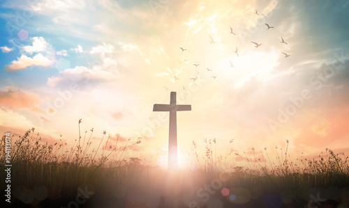 Fotografiet Ascension day concept: The cross on meadow autumn sunrise background
