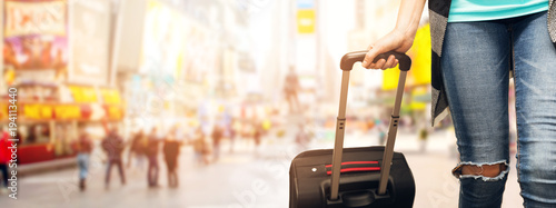 woman traveler with luggage at Time Square New York