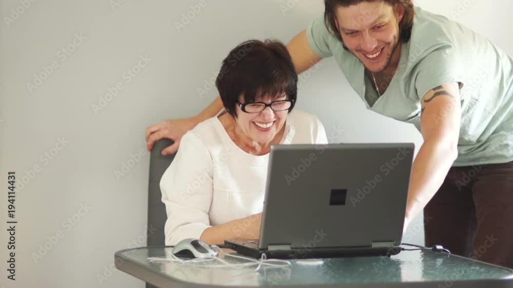 Pair of designers working together on a computer in their office. They sincerely laugh. Slow Motion Pair of designers working together on a computer in their office. They sincerely laugh. Slow Motion