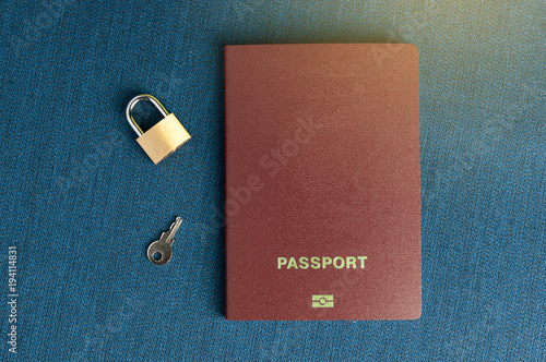 Summer light  clean red passport on a blue background with a lock and a key.