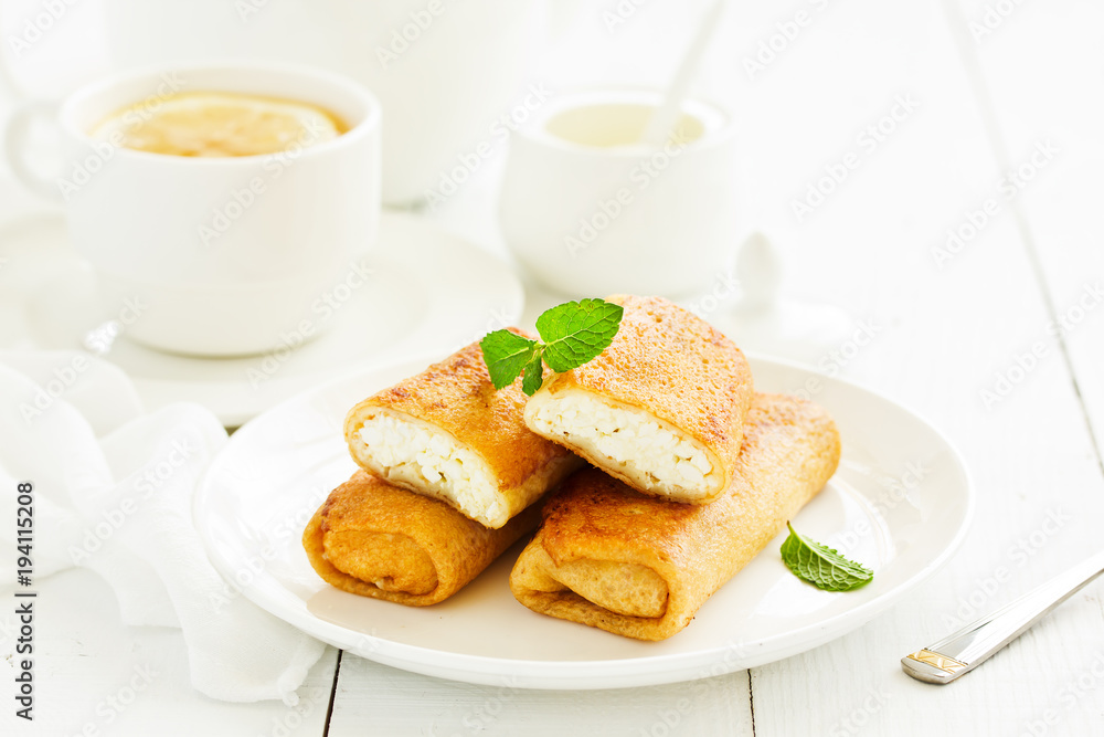 Russian crepes stuffed with curd and cherry. Russian crepes stuffed with curd and cherry.