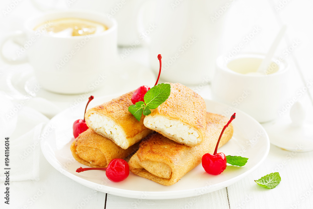 Russian crepes stuffed with curd and cherry.