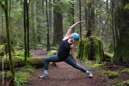 Young Caucasian Girl is practicing yoga in the rain forest. Taken in Capilano Canyon, North Vancouver, BC, Canada. © edb3_16