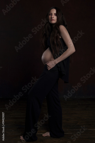 beautiful pregnant woman on dark background