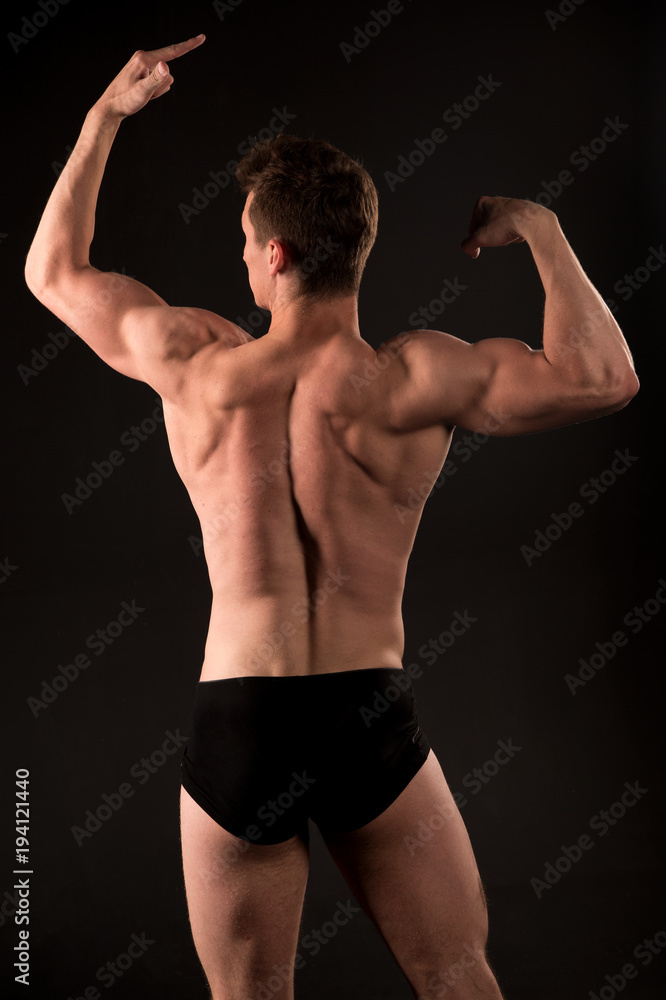 Man athlete with muscular body, torso, back view Man athlete with muscular body, torso, back view