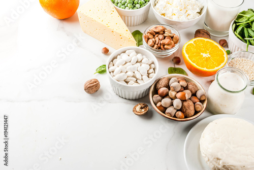 Healthy food concept. Set of food rich in calcium - dairy and vegan Ca products  white marble background copy space