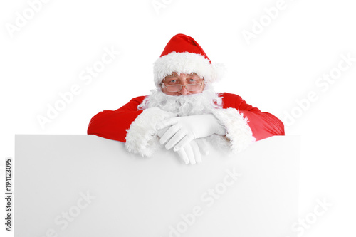 Santa Claus pointing in white blank sign with smile, isolated on white background © lenets_tan