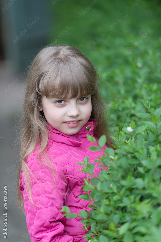 Small girl at green bush, spring Small girl at green bush, spring