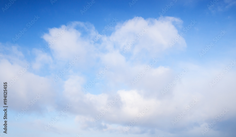 White cumulus clouds in blue sky, background