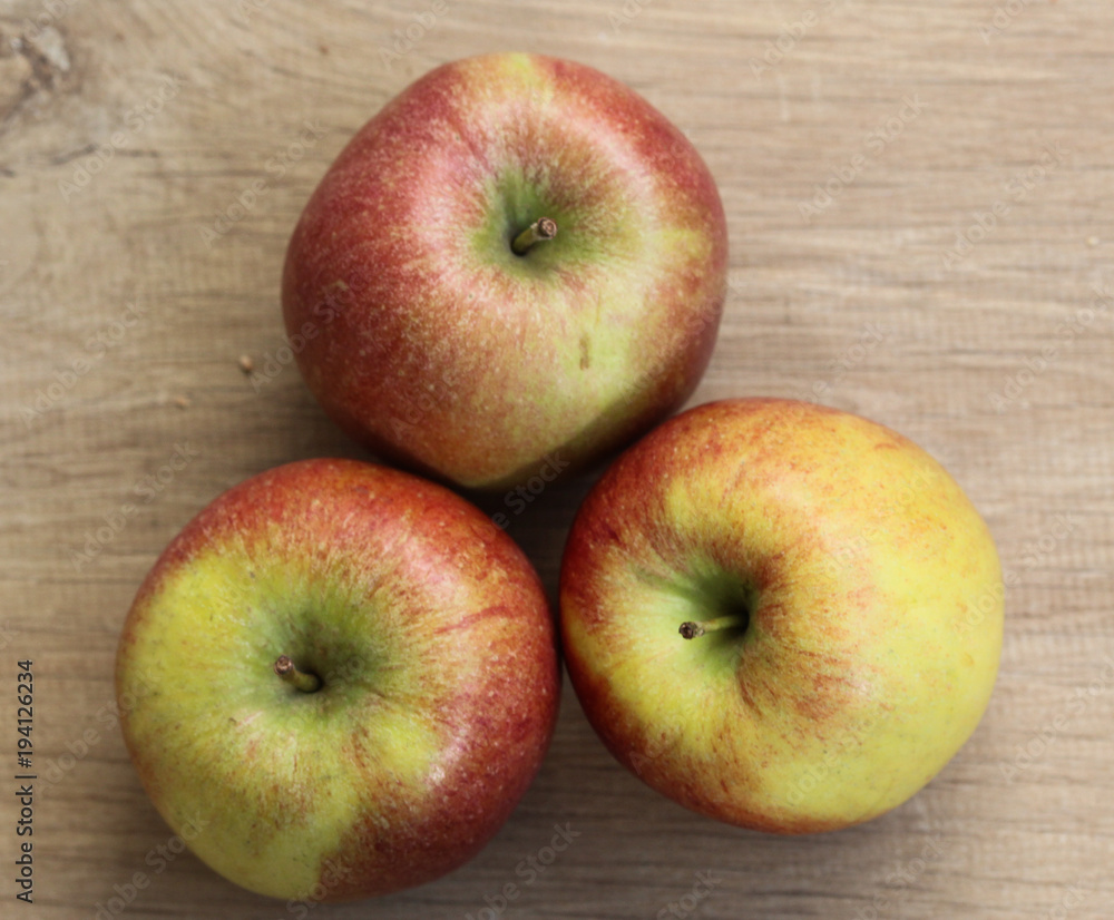 Red and yellow fresh braeburn apples on wooden background Red and yellow fresh braeburn apples on wooden background