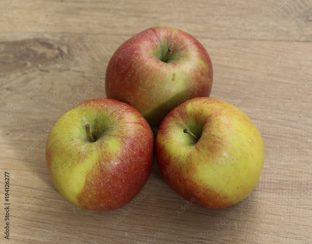 Red and yellow fresh braeburn apples on wooden background Red and yellow fresh braeburn apples on wooden background