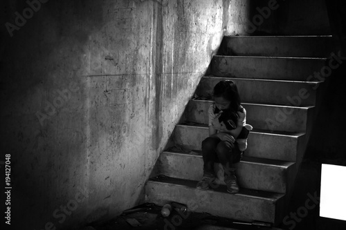 Murais de parede Depressed young girl sitting alone in an abandoned building