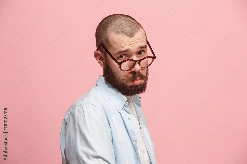 Beautiful man looking suprised and bewildered isolated on pink Beautiful man looking suprised and bewildered isolated on pink