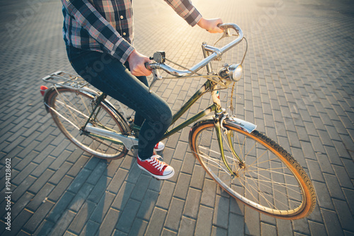 Woman riding a bike in the city during sunset