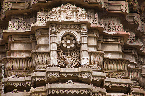 Carving details on the outer wall of Jhulta Minara, Ahmedabad, Gujarat photo