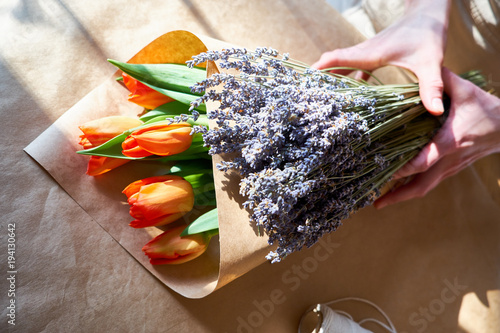 Gorgeous tulips and lavender on a wooden table